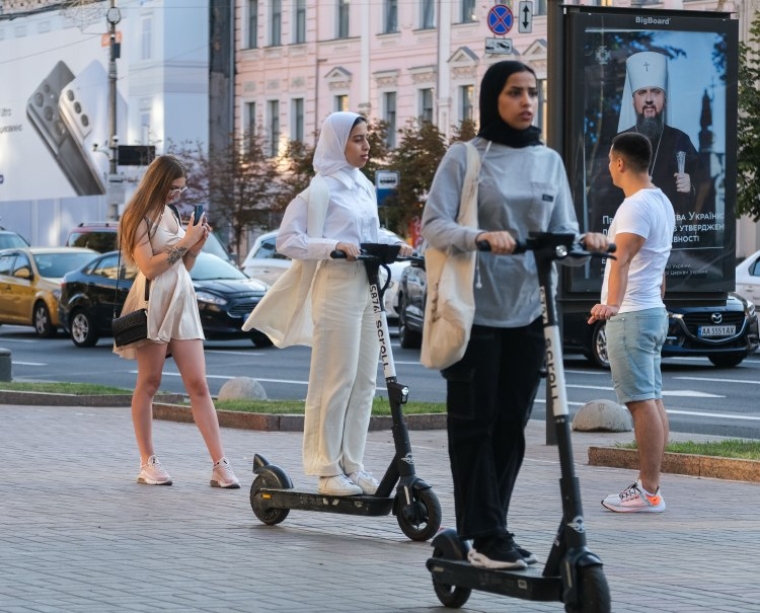 Туристы катаются на самокатах в Киеве