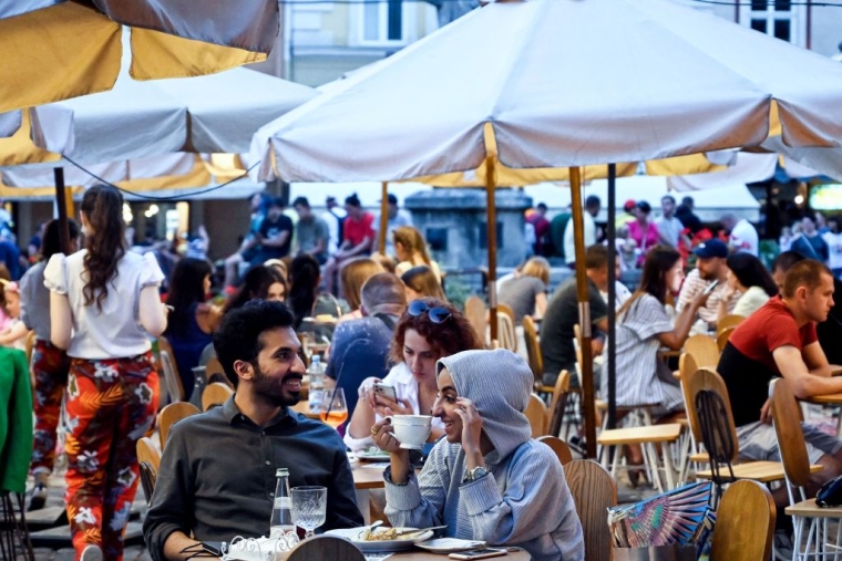 Туристы с Ближнего Востока в уличном кафе во Львове